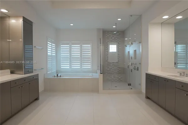 a bathroom with a bathtub a shower a sink and a bathtub