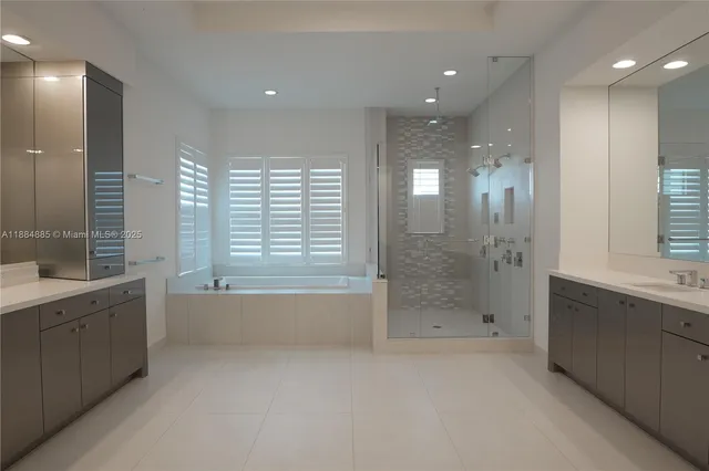 a bathroom with a bathtub a shower a sink and a bathtub