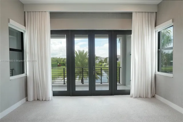 a view of empty room with floor to ceiling window