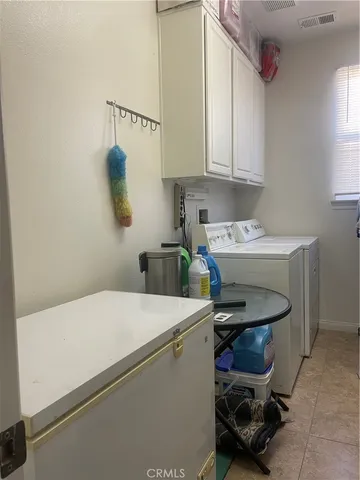 a dining room with furniture a chandelier and window