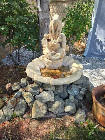 a kitchen with stainless steel appliances a stove a sink a refrigerator a center island and cabinets