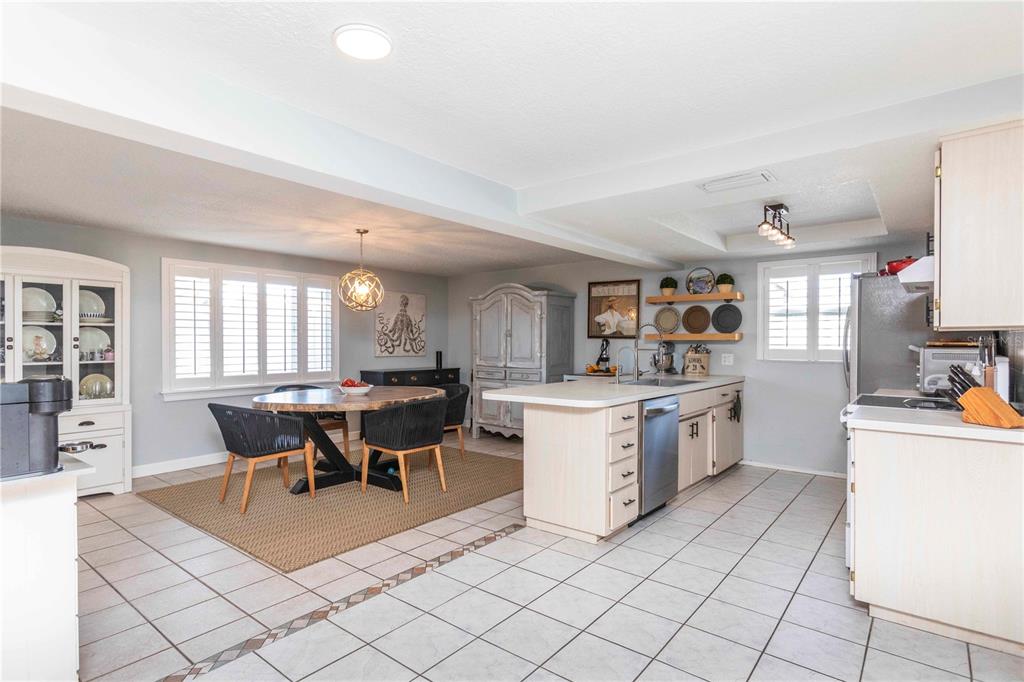 6324 Patella Avenue New Port Richey, FL 34653 - Photo 12 of 36 a kitchen with cabinets and chairs