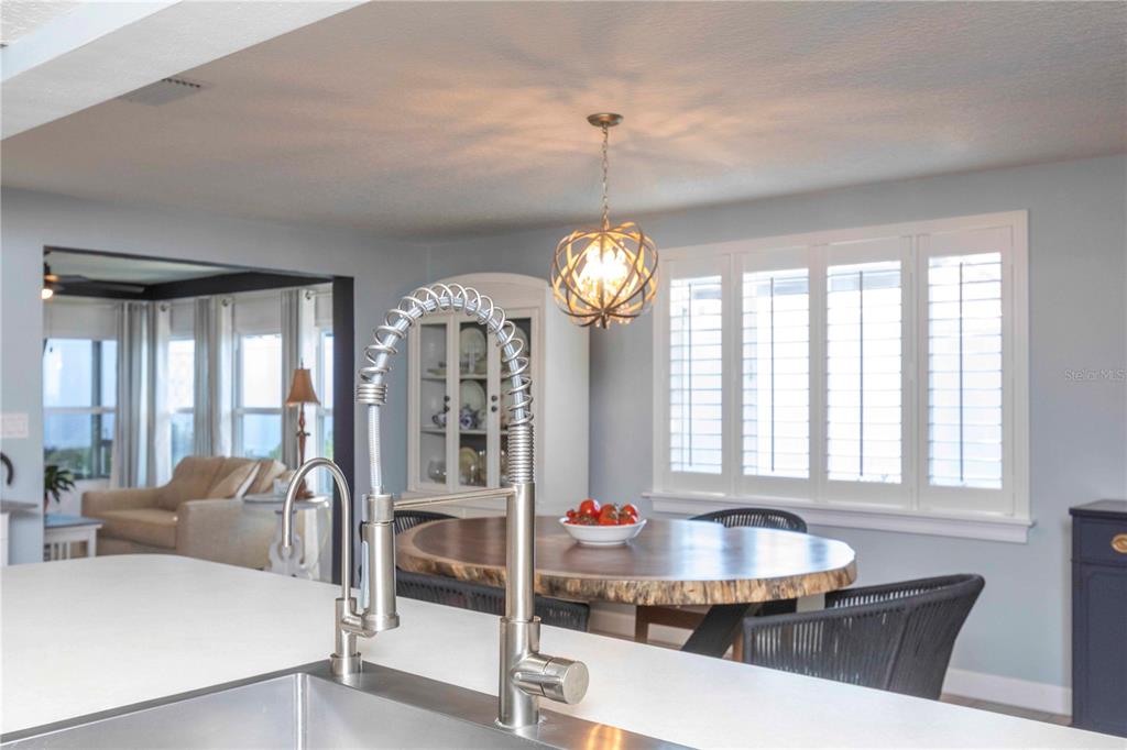 6324 Patella Avenue New Port Richey, FL 34653 - Photo 18 of 36 a very nice looking dining room with a large window and chandelier