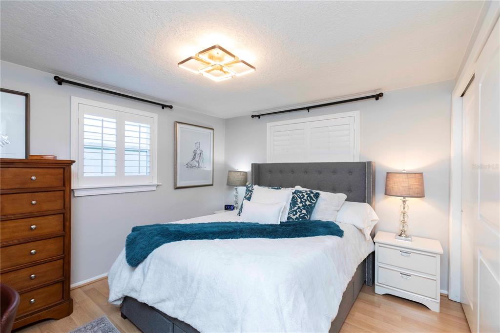 6324 Patella Avenue New Port Richey, FL 34653 - Photo 23 of 36 a bedroom with a bed and a night stand