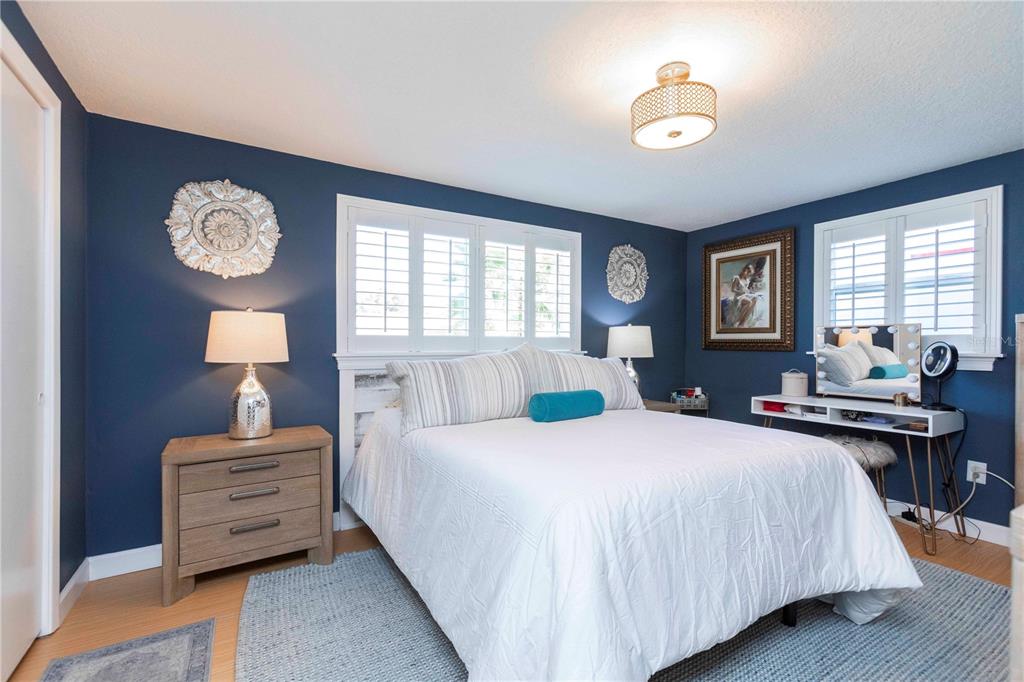 6324 Patella Avenue New Port Richey, FL 34653 - Photo 24 of 36 a bedroom with a bed and a chandelier