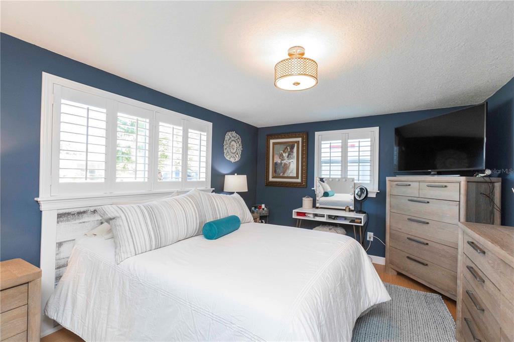 6324 Patella Avenue New Port Richey, FL 34653 - Photo 25 of 36 a bedroom with a bed and a flat screen tv