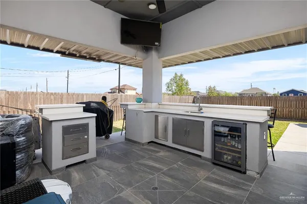 a kitchen with a stove sink and cabinets