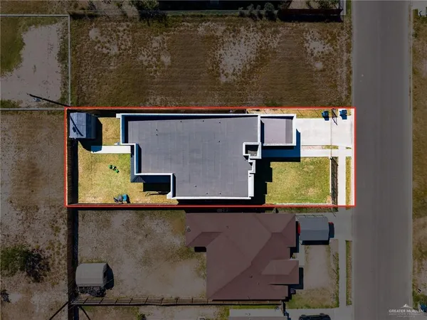 an aerial view of a house with a yard