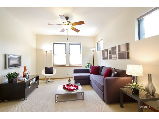 45 North Paulina Street, Unit 1 Chicago, IL 60612 - Photo 2 of 11 a living room with furniture and a flat screen tv