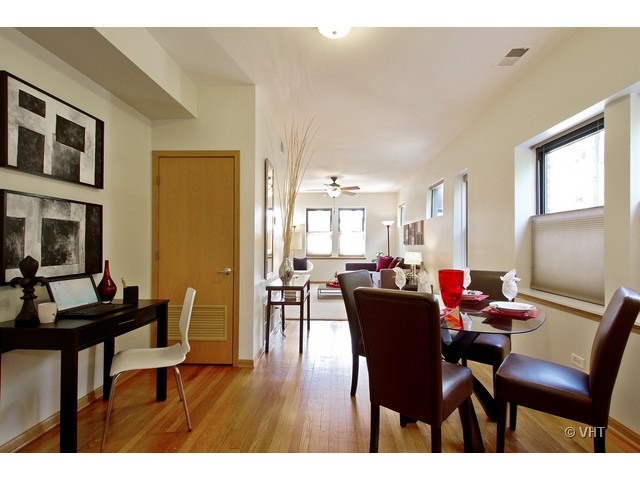 45 North Paulina Street, Unit 1 Chicago, IL 60612 - Photo 3 of 11 a view of a dining room with furniture and wooden floor