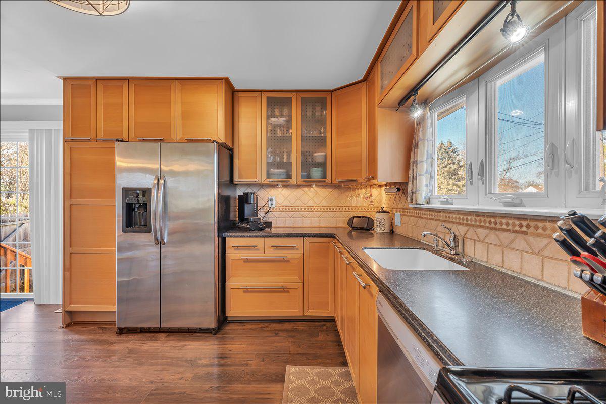 528 Rowand Avenue Glendora, NJ 08029 - Photo 11 of 24 a kitchen with stainless steel appliances granite countertop a sink and a refrigerator