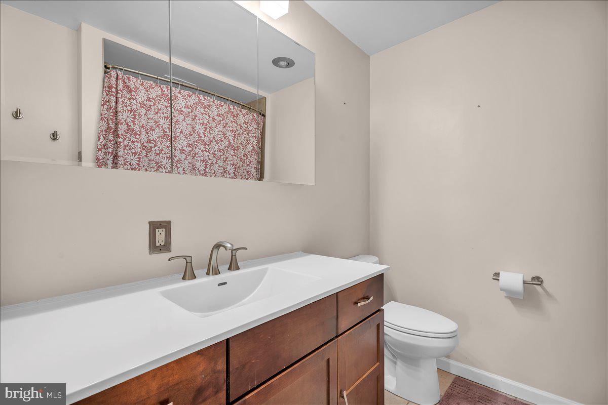 528 Rowand Avenue Glendora, NJ 08029 - Photo 14 of 24 a bathroom with a sink mirror and toilet