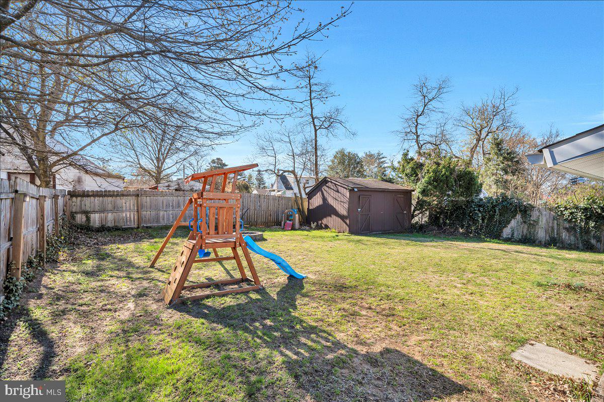 528 Rowand Avenue Glendora, NJ 08029 - Photo 21 of 24 a view of a backyard with a slide and large trees