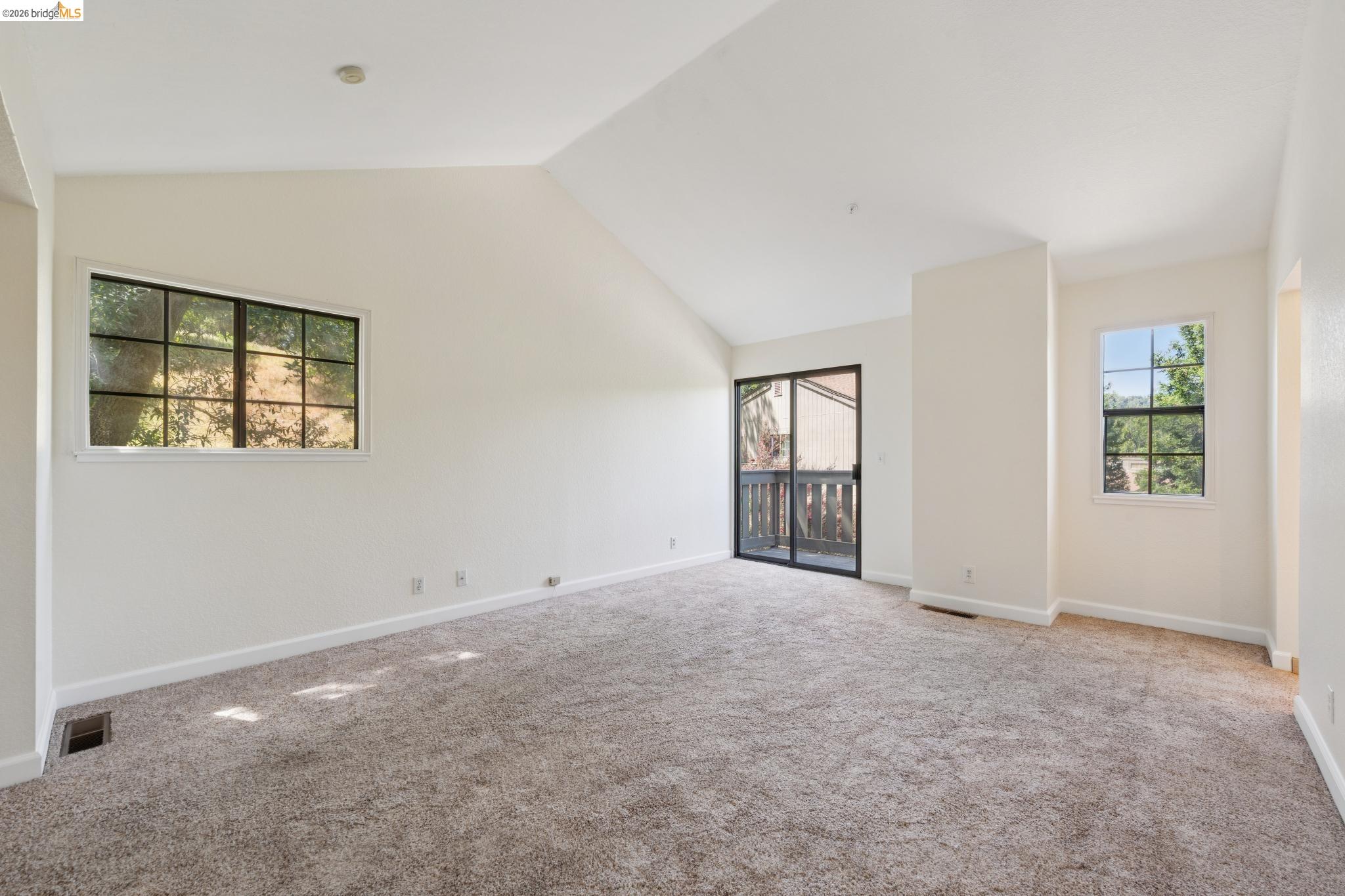 261 Redhawk Road Novato, CA 94949 - Photo 31 of 44 Spacious room featuring vaulted ceilings, plush carpet flooring, and multiple windows