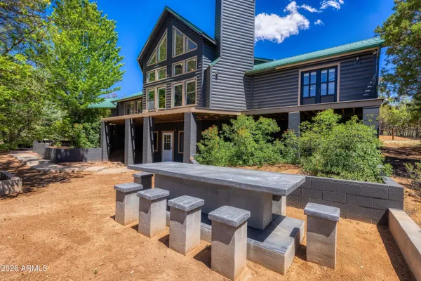 a view of a house with pool and chairs