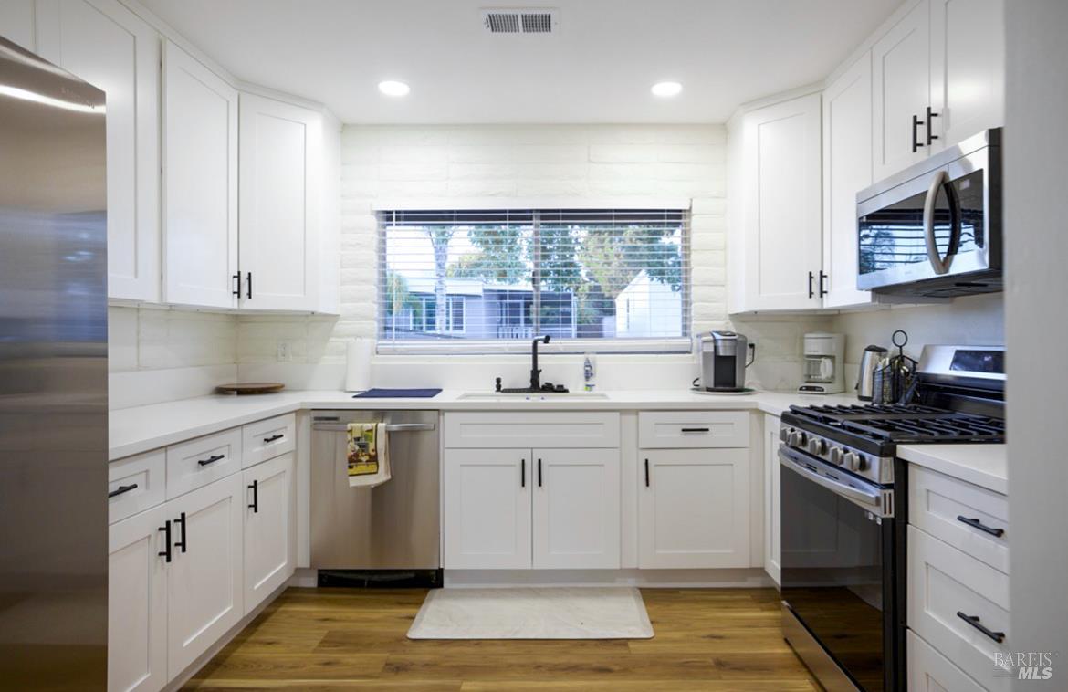 150 Silverado Trail, Unit 64 Napa, CA 94559 - Photo 18 of 21 a kitchen with a sink stove and cabinets