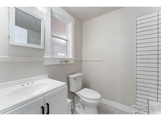 a bathroom with a sink a toilet and mirror