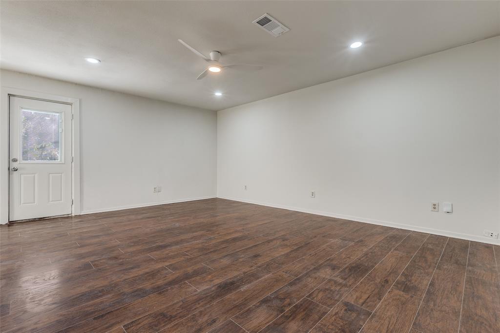 4728 Meadow Ridge Drive Dallas, TX 75236 - Photo 12 of 25 an empty room with wooden floor and windows