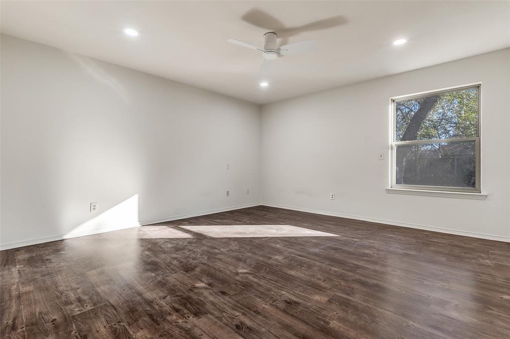 4728 Meadow Ridge Drive Dallas, TX 75236 - Photo 14 of 25 an empty room with wooden floor and windows