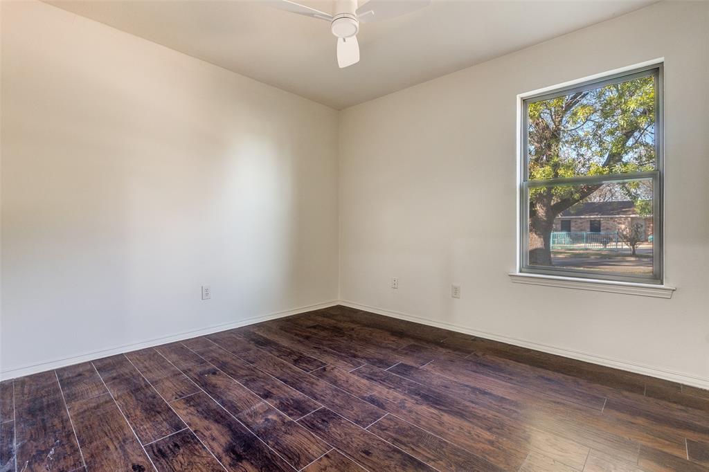 4728 Meadow Ridge Drive Dallas, TX 75236 - Photo 19 of 25 a view of empty room with wooden floor and fan