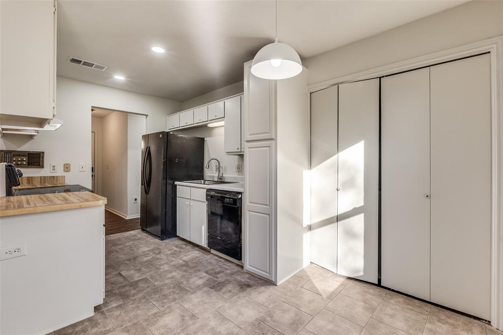 4728 Meadow Ridge Drive Dallas, TX 75236 - Photo 7 of 25 a kitchen with stainless steel appliances granite countertop a refrigerator and a stove top oven