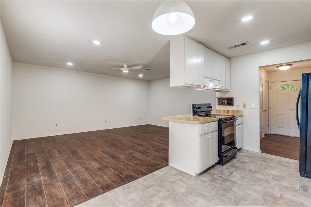 4728 Meadow Ridge Drive Dallas, TX 75236 - Photo 8 of 25 a kitchen with a stove and a refrigerator