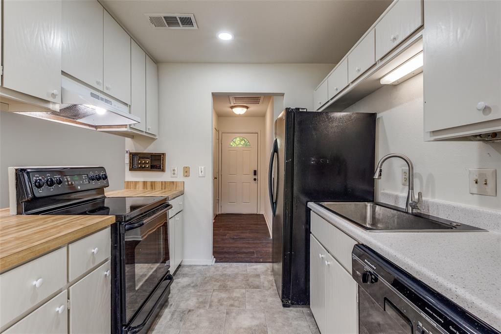 4728 Meadow Ridge Drive Dallas, TX 75236 - Photo 9 of 25 a kitchen with granite countertop a refrigerator and a sink