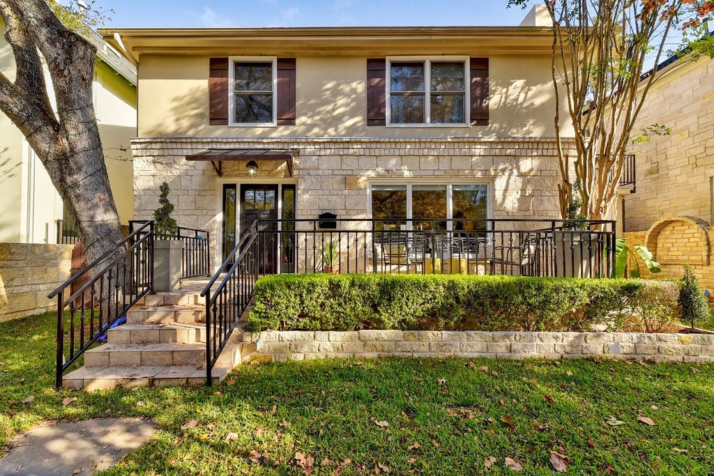 a front view of a house with a yard table and chairs