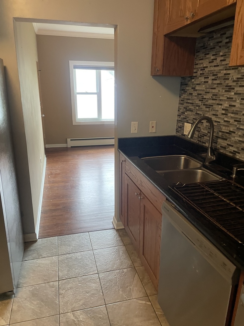 632 North Center Street, Unit 2W Naperville, IL 60563 - Photo 2 of 14 a kitchen with a sink and a stove top oven