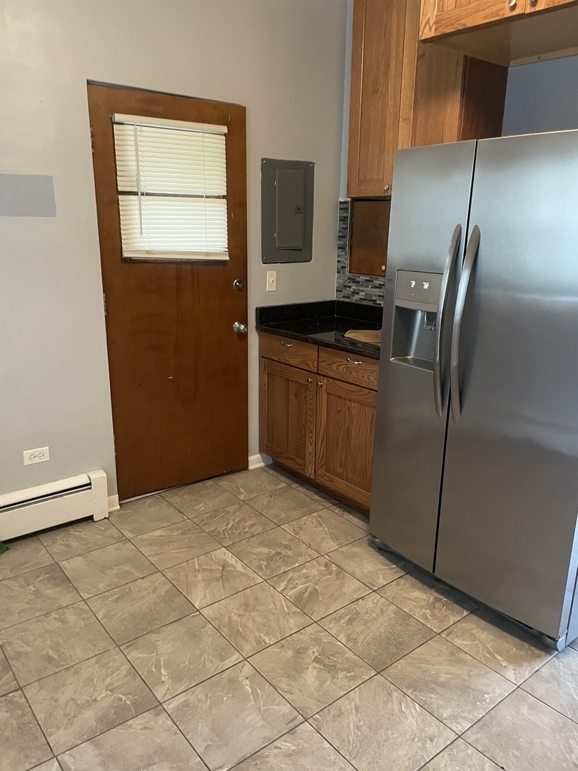 632 North Center Street, Unit 2W Naperville, IL 60563 - Photo 3 of 14 a kitchen with stainless steel appliances granite countertop a refrigerator and a stove