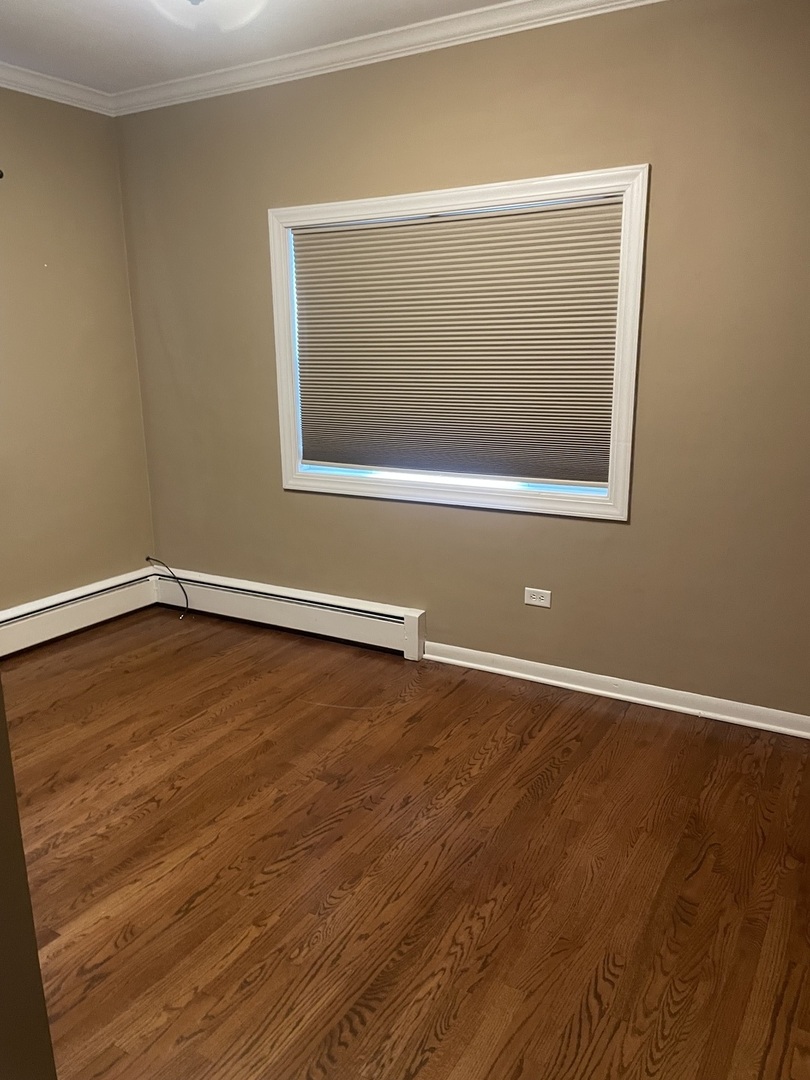 632 North Center Street, Unit 2W Naperville, IL 60563 - Photo 8 of 14 an empty room with wooden floor and windows