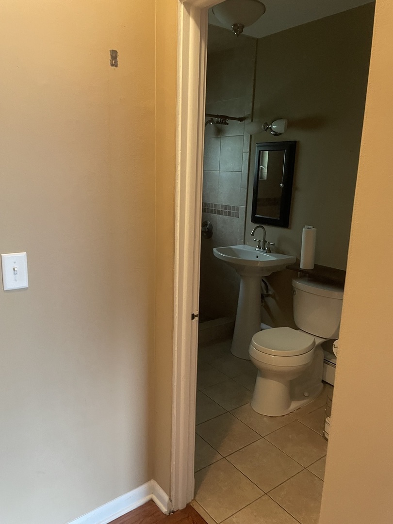 632 North Center Street, Unit 2W Naperville, IL 60563 - Photo 10 of 14 a bathroom with a toilet a sink and shower