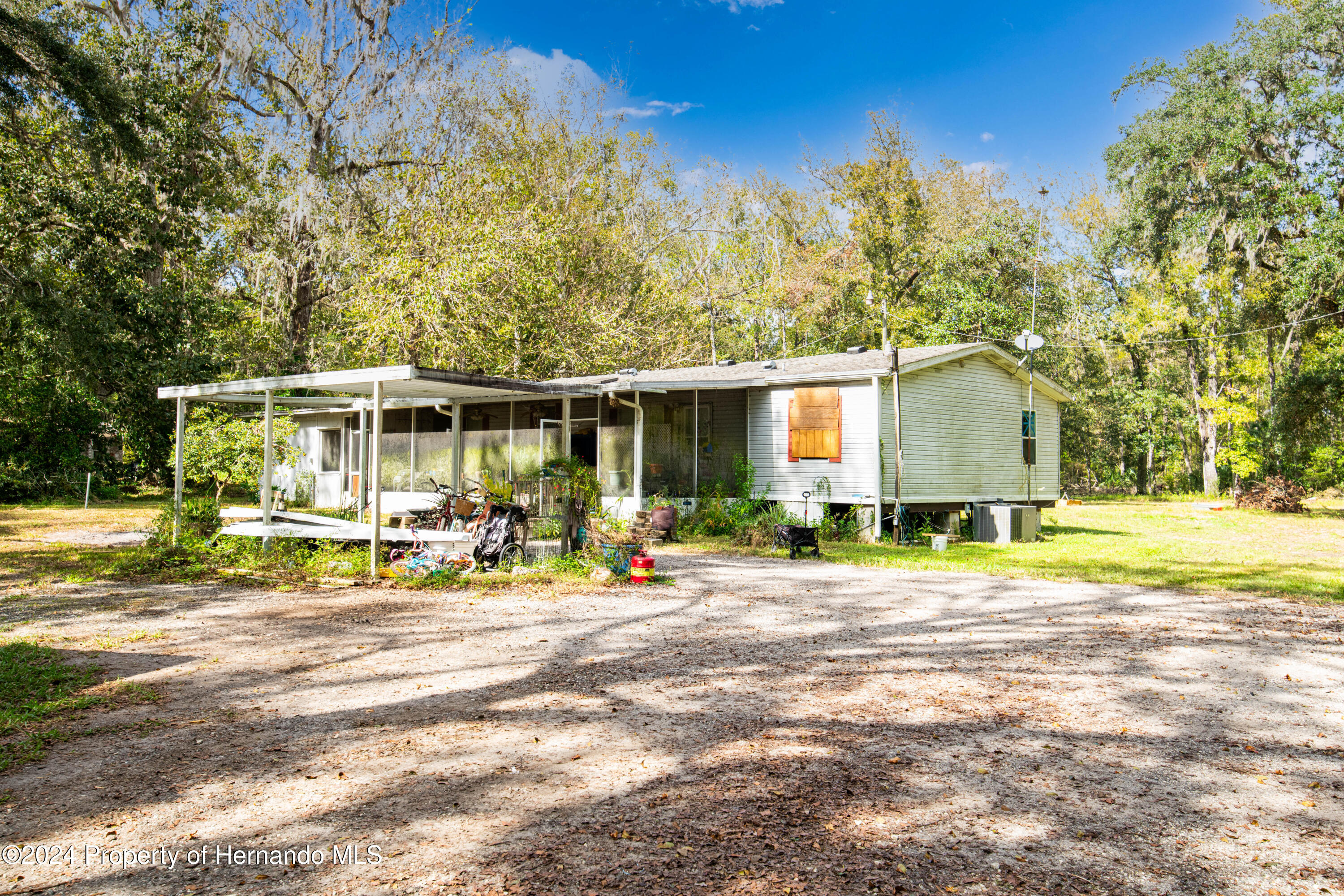 16109 Buczak Road Brooksville, FL 34614 - Photo 11 of 16 a view of a house with backyard and sitting area