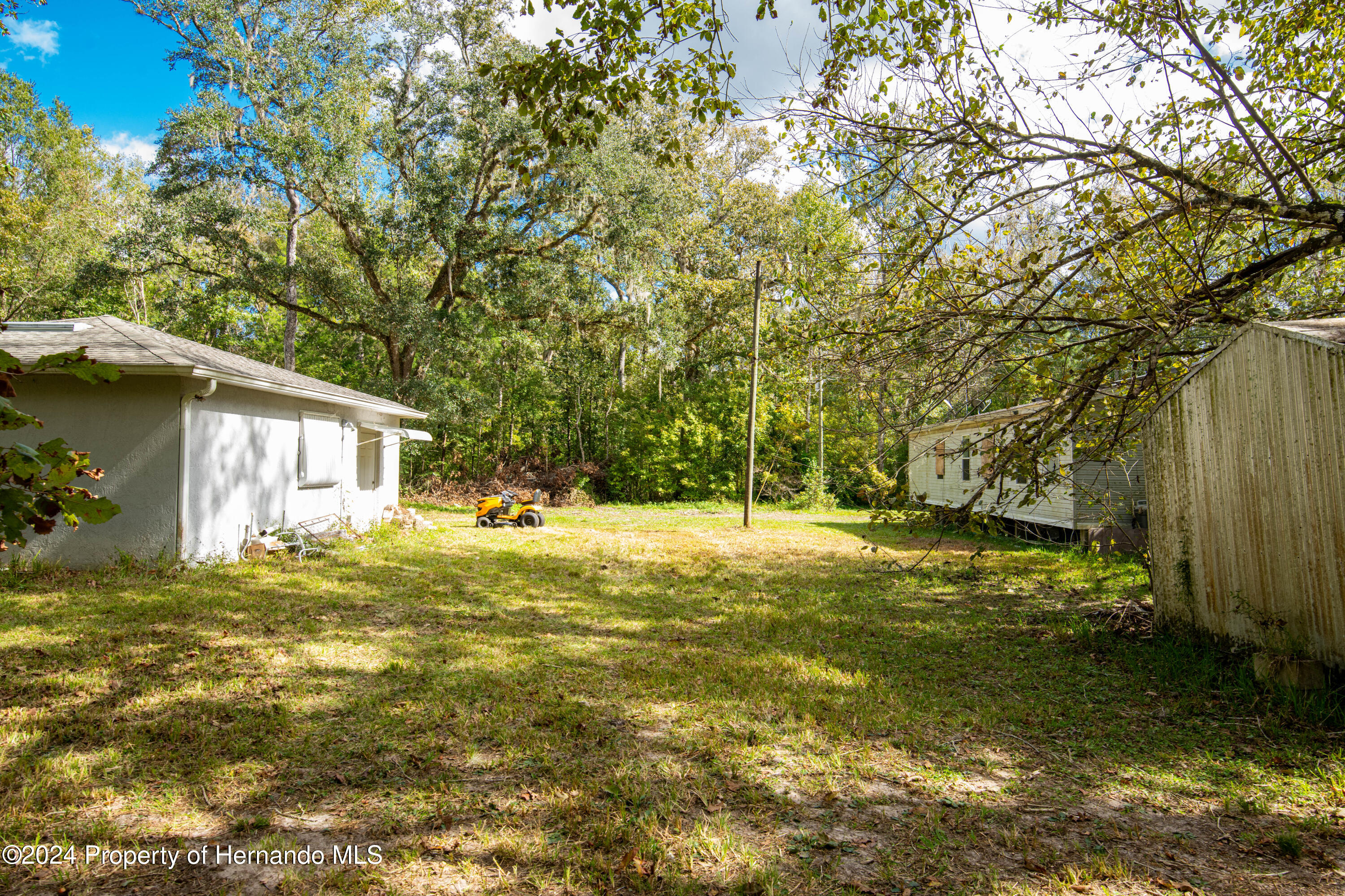 16109 Buczak Road Brooksville, FL 34614 - Photo 15 of 16 a view of a house with a yard