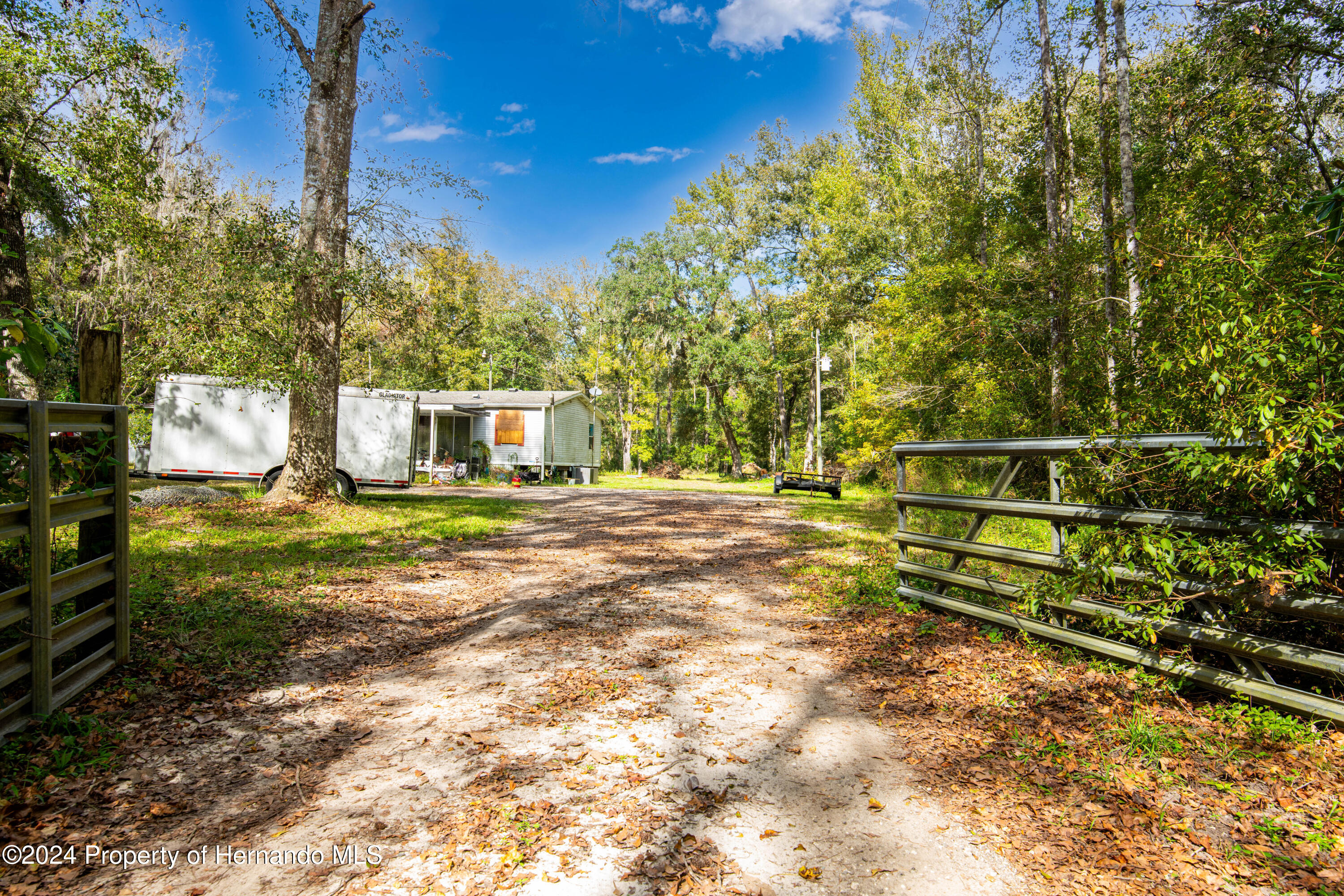 16109 Buczak Road Brooksville, FL 34614 - Photo 10 of 16 a house view with a bench