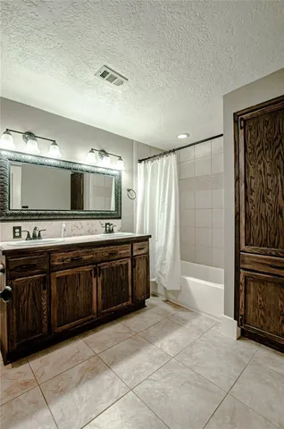 a spacious bathroom with a tub sink and a mirror