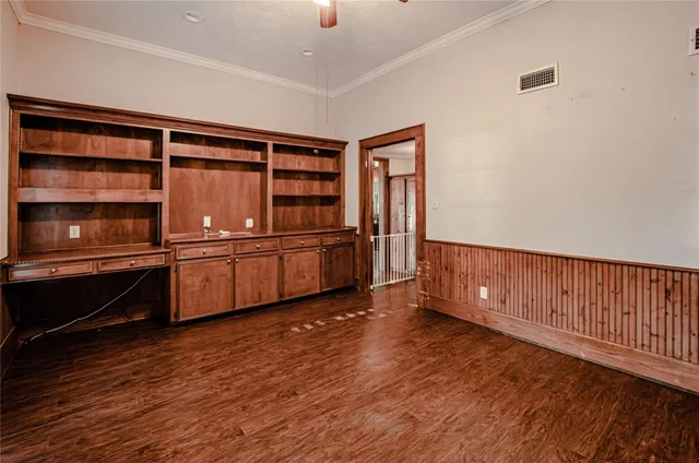 a view of a kitchen with furniture and wooden floor