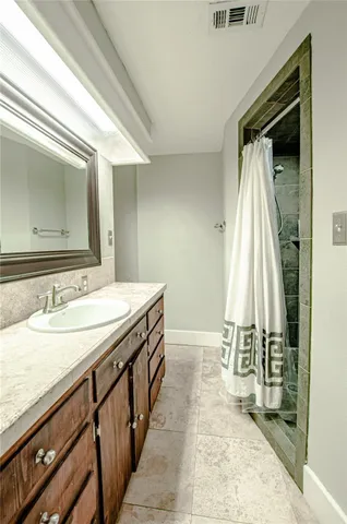 a bathroom with a double vanity sink and a mirror