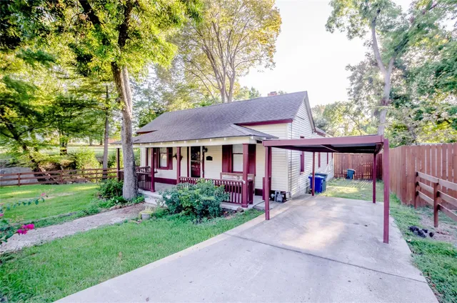a view of a house with garden and a trees
