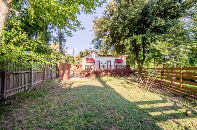 a view of yard with tree and wooden fence