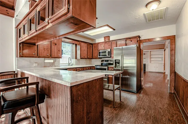 a kitchen with stainless steel appliances granite countertop a stove and a refrigerator