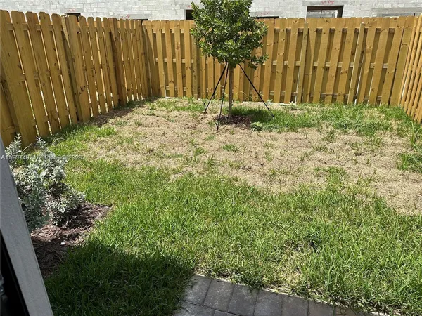a backyard of a house with grass and plants