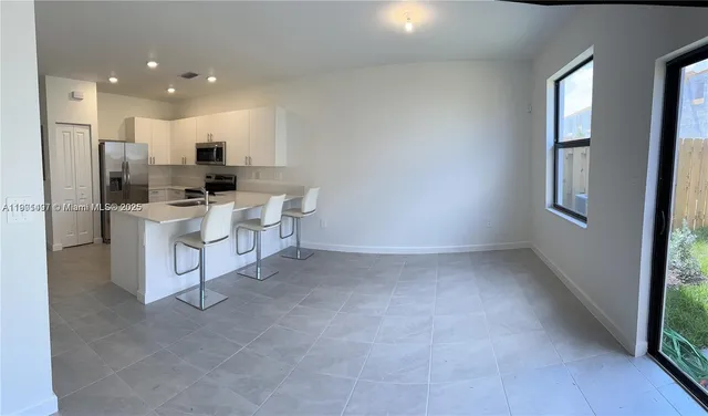 a kitchen with a sink cabinets and stainless steel appliances