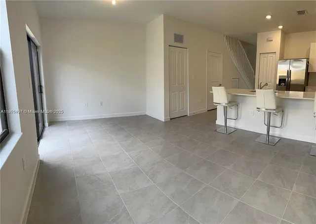 a view of kitchen with furniture and a refrigerator