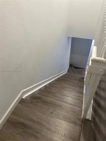 a view of wooden floor in an empty room