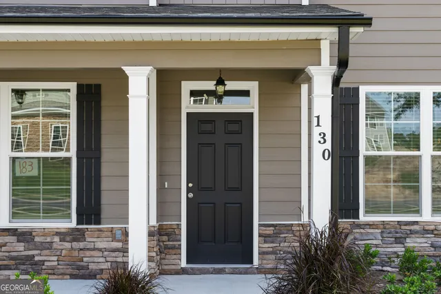 a front view of a house with a window and glass door