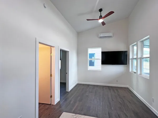 wooden floor in an empty room with a window