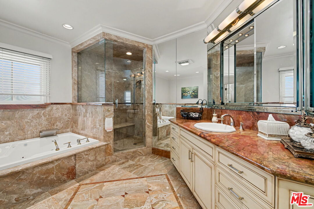 204 Foothill Road Beverly Hills, CA 90210 - Photo 22 of 38 a bathroom with a granite countertop tub sink and mirror
