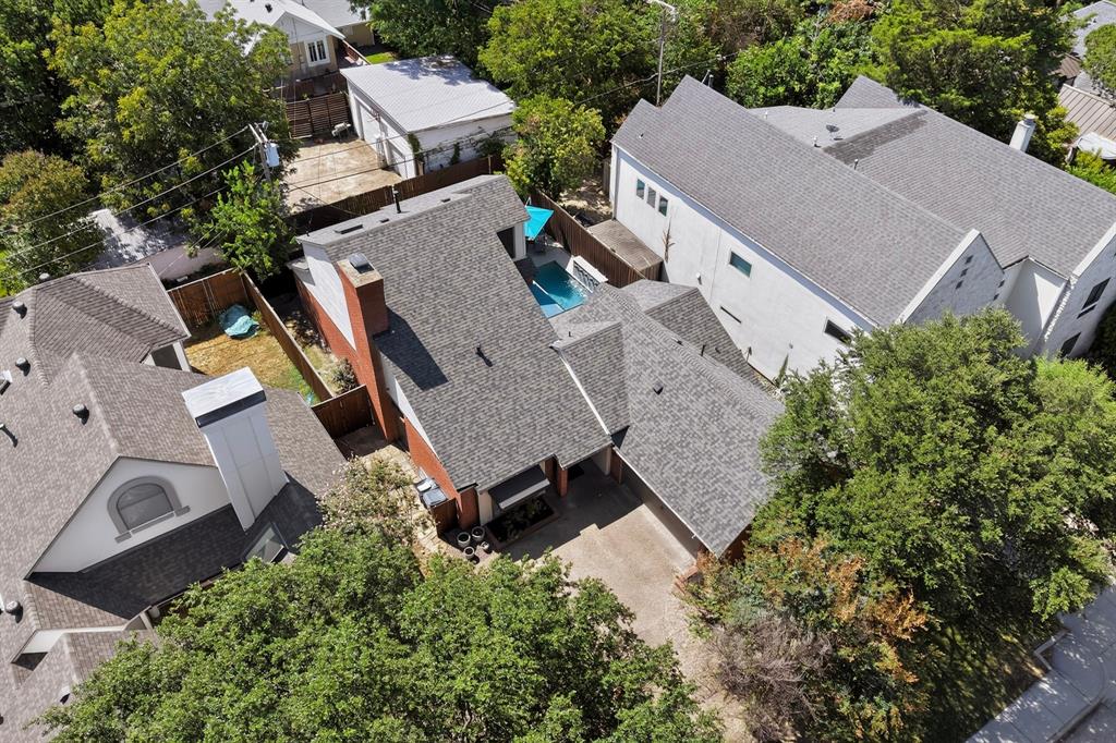 1526 Abrams Road Dallas, TX 75214 - Photo 37 of 38 Property featuring a gray shingle roof, a red brick chimney, and mature trees