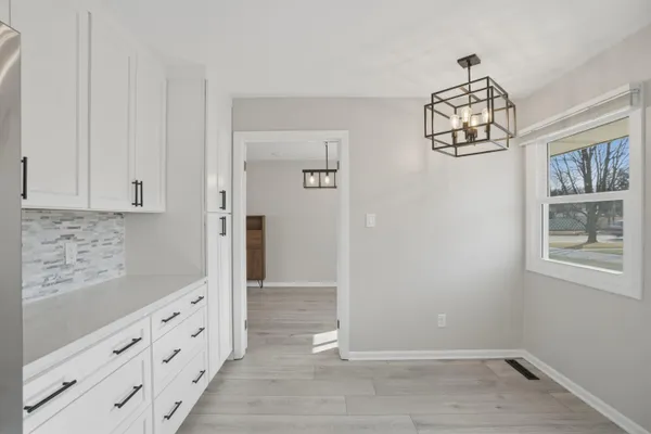 a view of hallway with chandelier